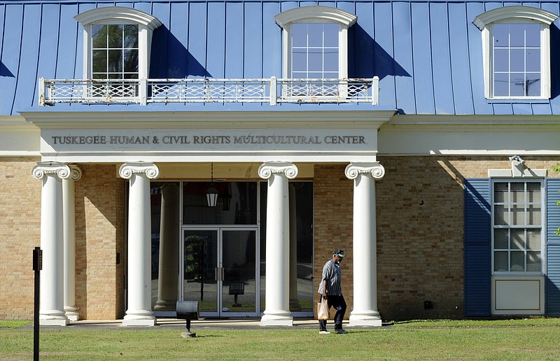 
              In this Tuesday, April 4, 2017 photo, an unidentified man walks past the Tuskegee Human and Civil Rights Multicultural Center in Tuskegee, Ala. The Trump administration is opposing a bid to use unclaimed money from a legal settlement to fund the museum, which includes exhibits honoring victims of the government's infamous Tuskegee syphilis study. (AP Photo/Jay Reeves, File)
            