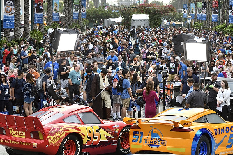
              A crowd of people wait to enter the D23 Expo as crews do interviews outside the Anaheim Convention Center in Anaheim, Calif., on Friday, July 14, 2017. (Jeff Gritchen/The Orange County Register via AP)
            