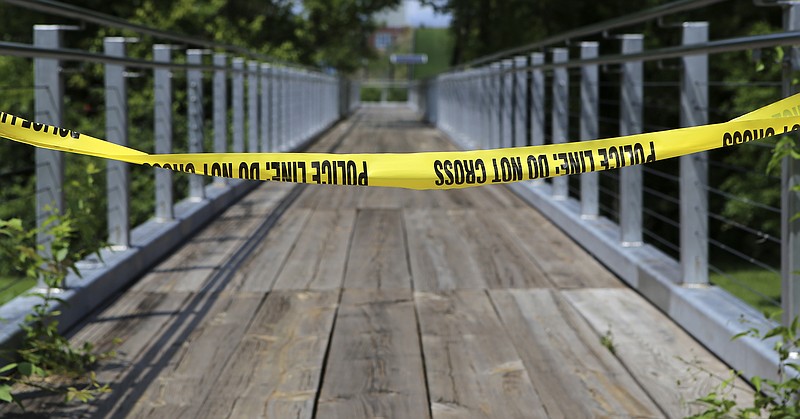 Crime scene tape blocks the pier at Renaissance Park where a woman's body was found early Sunday, July 16, 2017, following reports to police about a shooting.