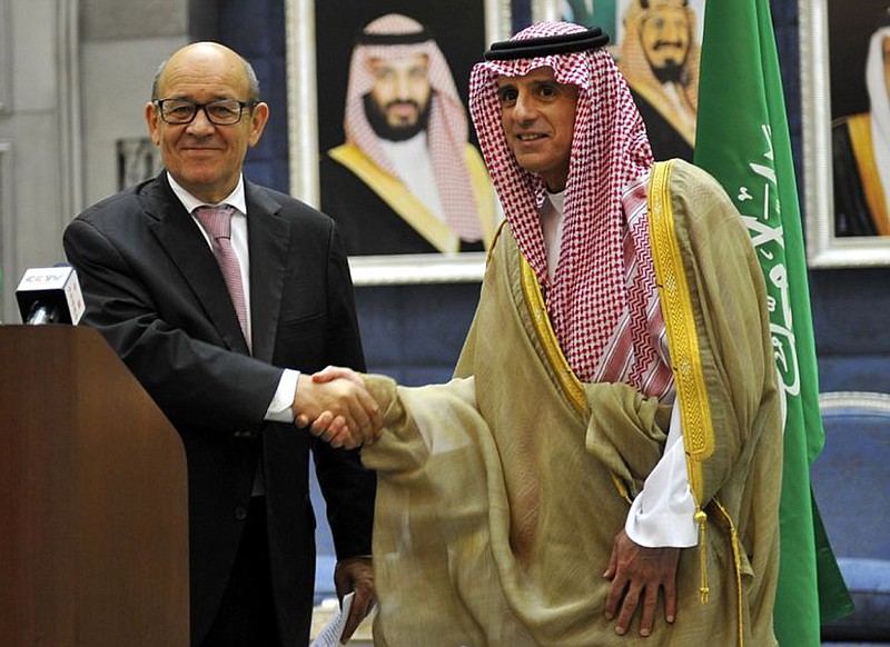 
              In this Saturday, July 15, 2017 photo released by Saudi Press Agency, Saudi Foreign Minister Adel al-Jubeir, right, shakes hands with France Foreign Minister Jean-Yves Le Drian during a join press conference in Jiddah, Saudi Arabia. France's foreign minister on Saturday called on Qatar's neighbors to immediately lift measures impacting thousands of people in the Gulf, becoming the latest foreign diplomat to visit the region and attempt to help find a resolution to a crisis that has dragged on for more than a month. (Saudi Press Agency via AP)
            