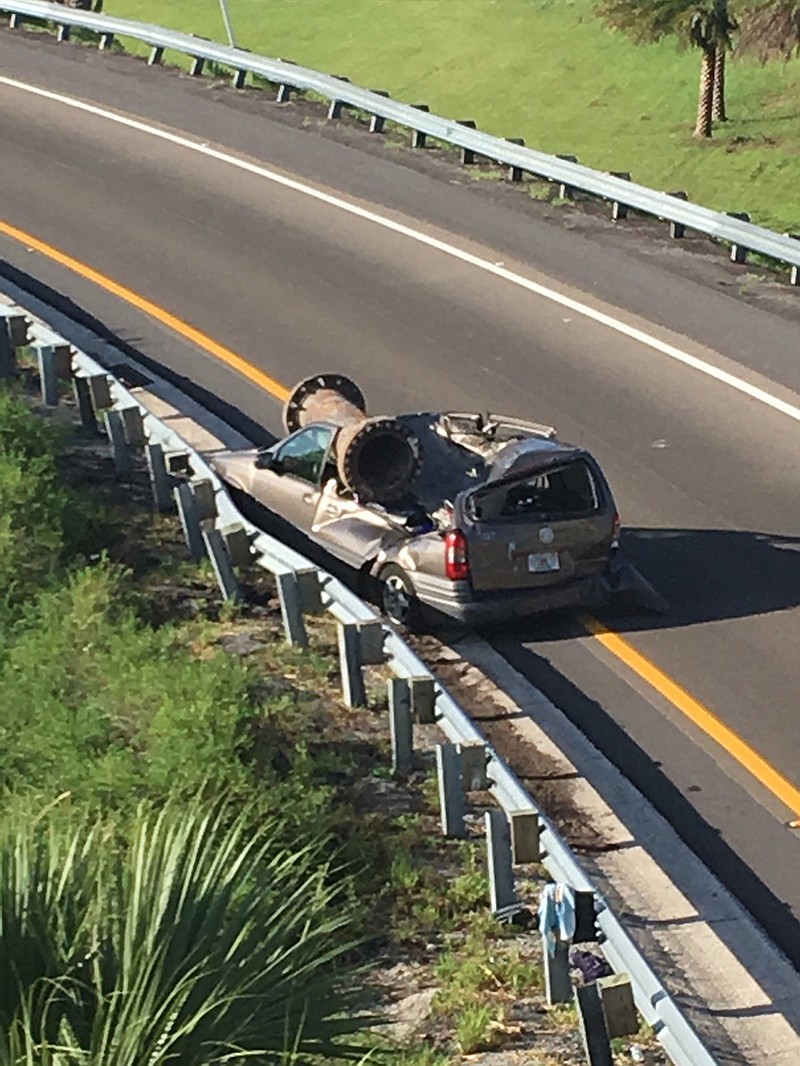 
              In this photo provided by the Florida Highway Patrol, a van is shown with a piece of scrap metal on its roof  in Orange County, Florida, on Saturday, July 15, 2017. The highway patrol said the scrap metal fell from a truck that had lost control and overturned on an overpass. The van driver and the driver of the semi had only minor injuries. (Florida Highway Patrol via AP)
            