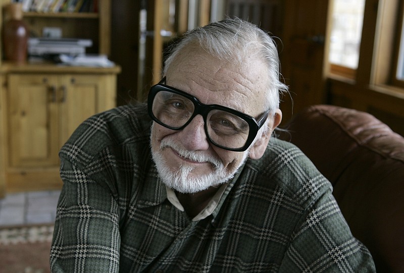 In this Monday, Jan. 21, 2008 file photo, director and writer George Romero poses for a photograph while talking about his film "Diary of the Dead' at the Sundance Film Festival in Park City, Utah. George Romero, whose classic "Night of the Living Dead" and other horror films turned zombie movies into social commentaries and who saw his flesh-devouring undead spawn countless imitators, remakes and homages, has died. He was 77. Romero died Sunday, July 16, 2017, following a battle with lung cancer. (AP Photo/Amy Sancetta, File)