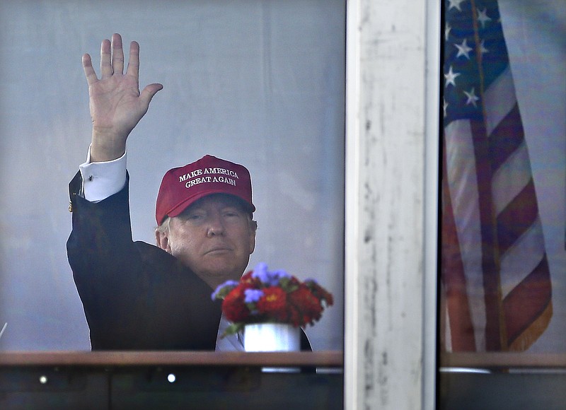 
              President Donald Trump waves to spectators as he watches the third round of the U.S. Women's Open Golf tournament from his observation booth, Saturday, July 15, 2017, in Bedminster, N.J. (AP Photo/Seth Wenig)
            