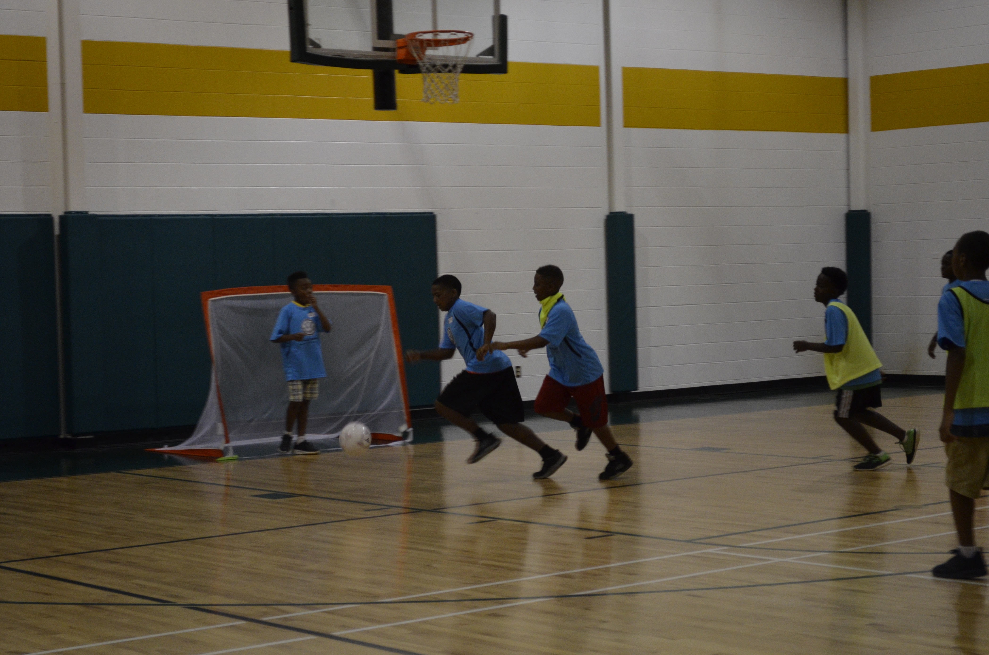 Boys at the Shepherd YFD Center attempt to gain control of the ball. The two teams scrimmaging are just some of the many students who participate in Operation Get Active, which seeks to expose kids to soccer at an early age. The group offers programs throughout the summer and currently works in 10 area elementary schools.