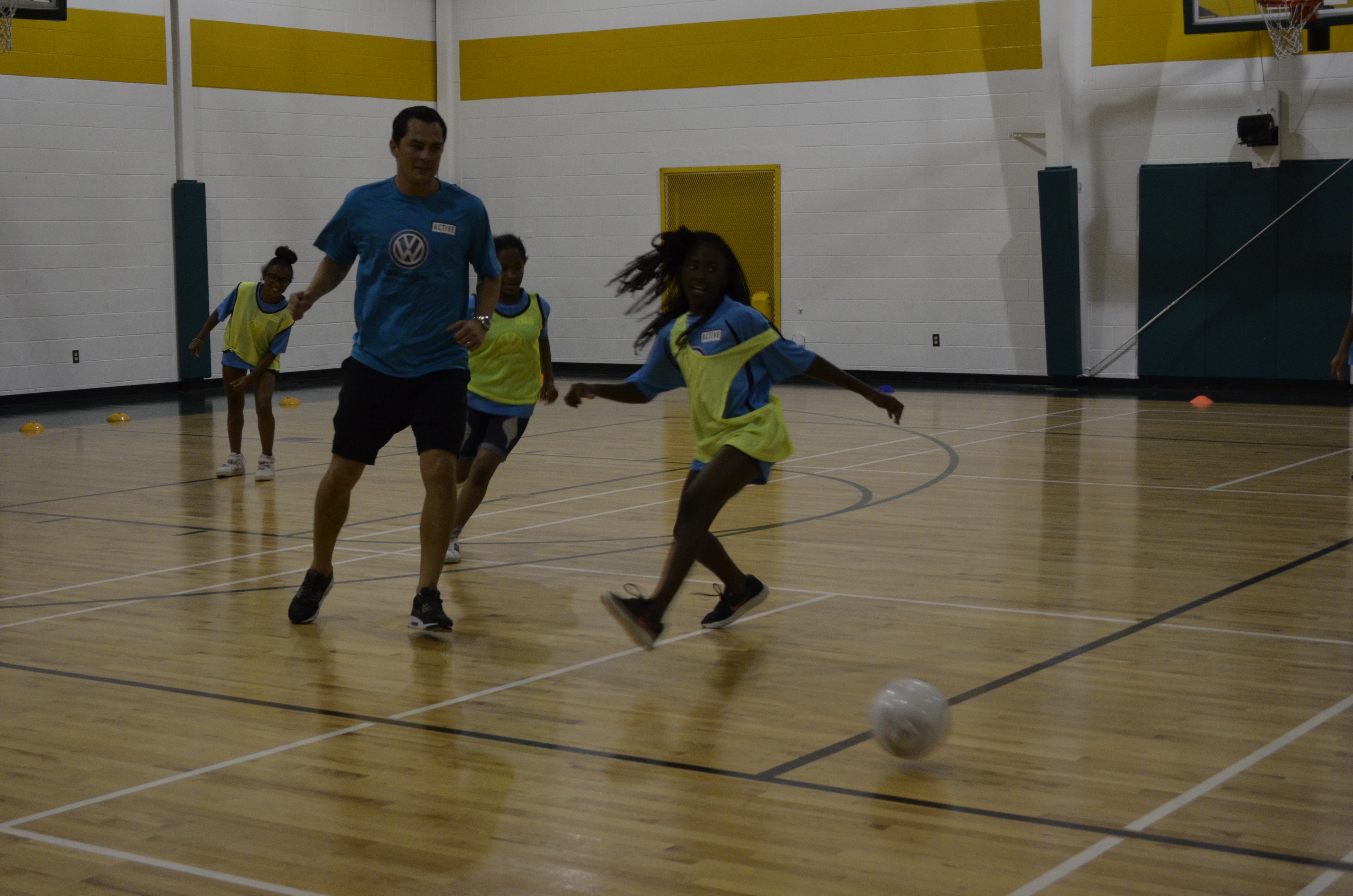 Operation Get Active participants attempt to keep the ball away from German soccer star and current Tampa Bay Rowdies player Marcel Schafer during a scrimmage match.