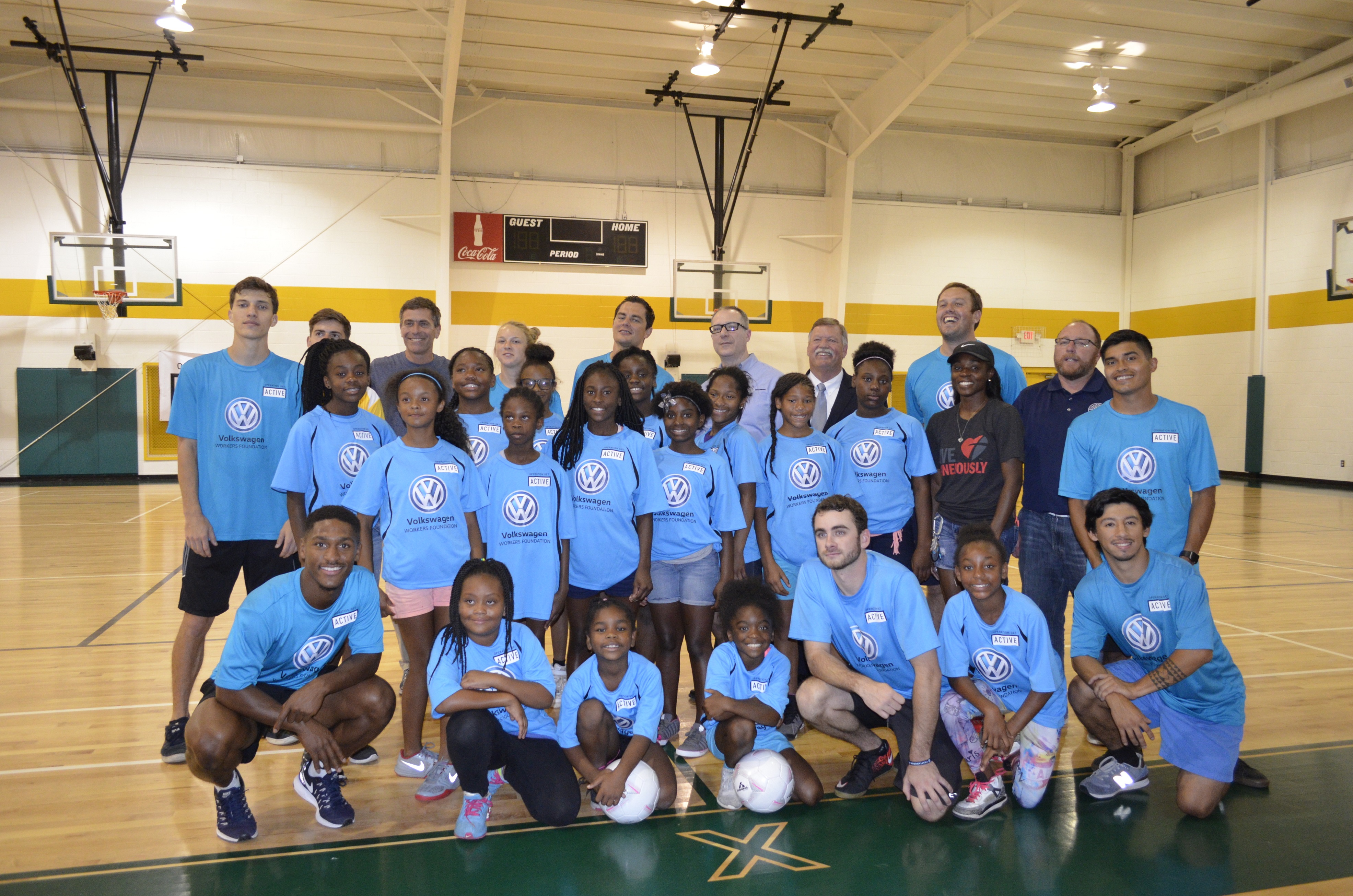 Operation Get Active leaders and the girls who participate in the program at the Shepherd YFD Center pose for a photo with German soccer star and current Tampa Bay Rowdies player Marcel Schafer, back center.