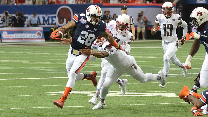 Auburn senior safety Tray Matthews, shown here returning an interception in the 2015 opening win over Louisville in Atlanta, began his college career at Georgia in 2013.