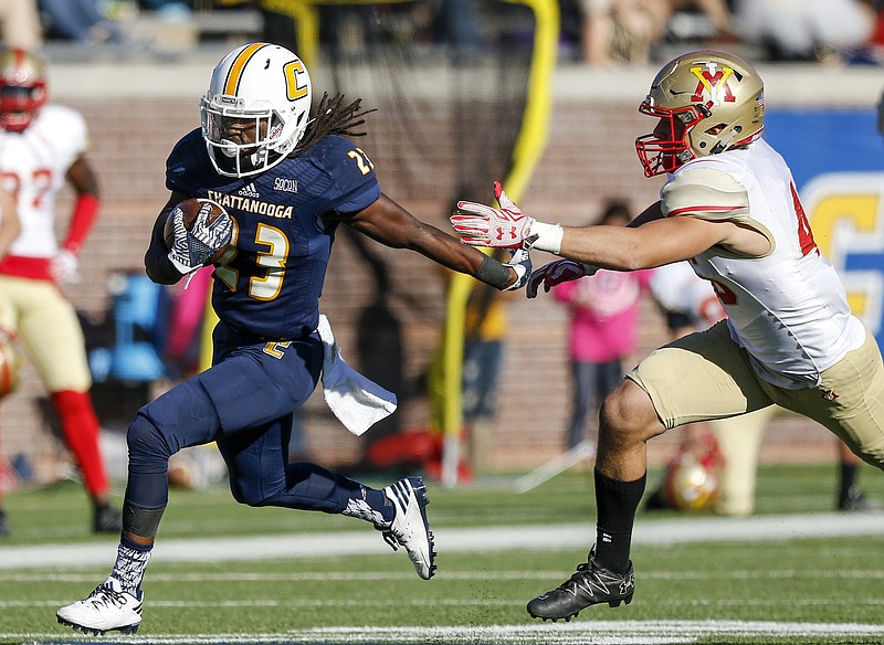 UTC running back Richardre Bagley breaks away from VMI defensive back Greg Sanders  on a touchdown run during the Mocs' home football game against the VMI Keydets at Finely Stadium on Saturday, Oct. 22, 2016, in Chattanooga, Tenn.