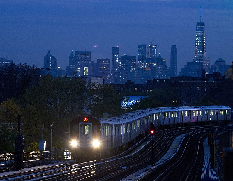 
              FILE - In this May 11, 2016, file photo, a No. 7 subway train rides the rails in the Queens borough of New York, with the Manhattan skyline in the background. On Monday, July 17, 2017, the Federal Reserve of New York releases its July survey of manufacturers in the state. (AP Photo/Mark Lennihan, File)
            