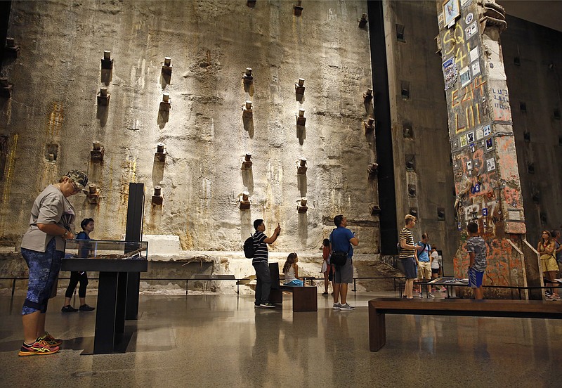 
              In this July 11, 2017 photo, visitors to the Foundation Hall at the National September 11 Memorial and Museum view the slurry wall, rear, and a beam from one of the World Trade towers, right, that was preserved by rescue and recovery workers at the site in New York. Last winter the U.S. tourism industry worried about a "Trump slump," fearing that Trump administration policies might discourage international travelers from visiting the U.S. But statistics from the first half of 2017 suggest that the travel to the U.S. is robust and a number of sectors have reported increased international visitation, with one expert calling it a "Trump bump." The museum is among those reporting more international visitors this year compared to the same period in 2016. (AP Photo/Kathy Willens)
            