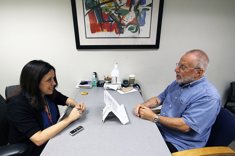 
              In this July 6, 2017 photo, Kim Mueller, left, administers a test to Alan Sweet, in which he describes an illustration, as part of a University of Wisconsin-Madison study on dementia. The study found that for some people subtle changes in everyday speech can be correlated with early mild cognitive impairment, which can be a precursor to Alzheimer's disease. (AP Photo/Carrie Antlfinger)
            