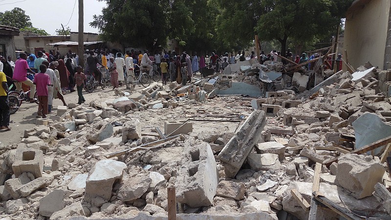 
              People gather at the site of a suicide bomb attack in Maiduguri, Nigeria, Monday, July 17, 2017. Several people were killed after a suspected female suicide bomber detonated at a mosque in northeastern Nigeria. (AP Photo/Jossy Ola)
            