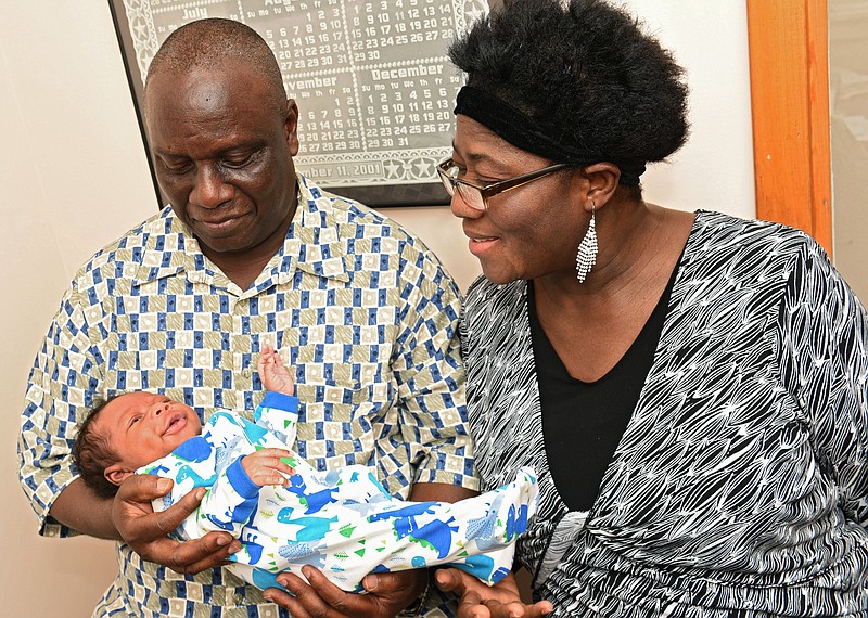 
              In a Thursday, July 13, 2017 photo, Isaiah Somuah Anim, 59, and his wife Akosua Budu Amoako, 59, hold their son Isaiah Somuah Anim, Jr. in Dr. Khushru Irani's office in Niskayuna, N.Y. Budu says she and her husband had tried for years to get pregnant after they married 38 years ago, but eventually stopped trying.  (Lori Van Buren/The Albany Times Union via AP)
            