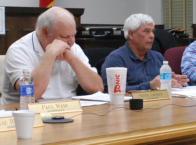 Jasper, Tenn., Alderman Steve Looney, left, and Mayor Paul Evans, right, discuss the smart meter purchase in 2014.