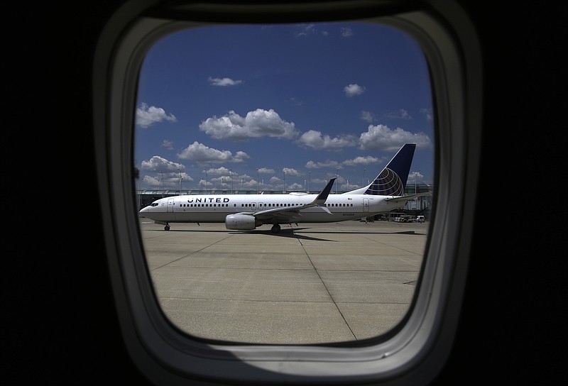 
              In this June 27, 2017, photo, a United Airlines jet taxis to a gate at O'Hare International Airport in Chicago. United Continental Holdings, Inc. reports financial results, Tuesday, July 18, 2017. (AP Photo/Kiichiro Sato)
            