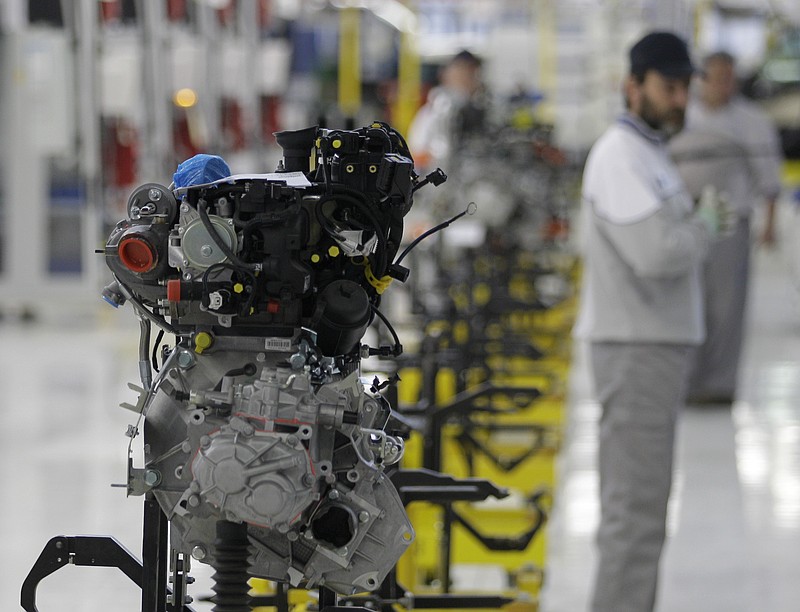 
              FILE This file photo from Monday, April 16, 2012 shows a factory worker looking at an engine of a Fiat 500 L car in the assembly hall in the Fiat factory, in Kragujevac, some 100 kilometers (70 miles) south of Belgrade, Serbia. Hundreds of Fiat workers marched from the Serbian factory on Tuesday, July 18, 2017, to demand higher wages. (AP Photo/Darko Vojinovic, File)
            