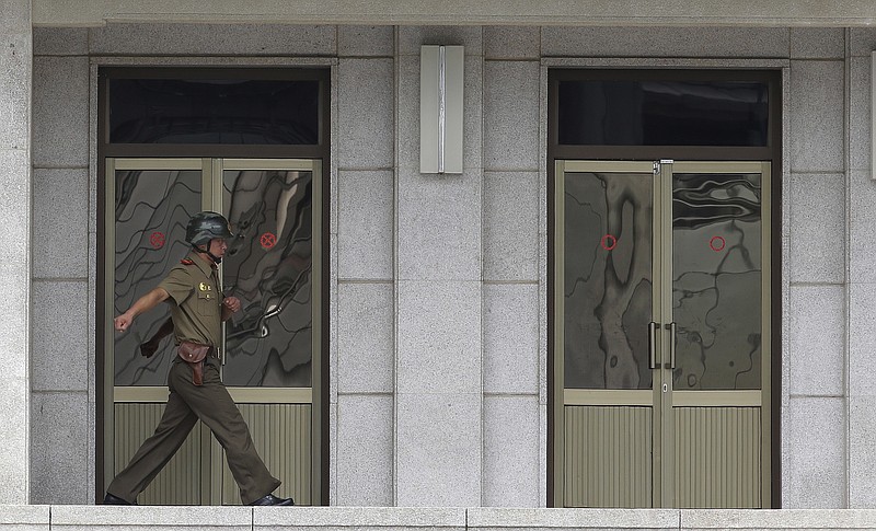 
              A North Korean army soldier walks at the border villages of Panmunjom in Paju, South Korea, Wednesday, July 19, 2017. Panmunjom is located inside the heavily mined Demilitarized Zone that serves as a border between the Koreas, and the main road to the zone is lined with barb-wired fences and security watchtowers for kilometers (miles). (AP Photo/Ahn Young-joon)
            