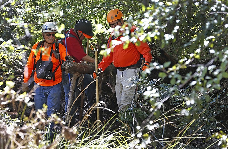 
              Members of the Tonto Rim Search and Rescue Team comb the muddy East Verde River near the entrance to the First Crossing recreation area during the search and rescue operation for a victim in a flash flood Monday, July 17, 2017, in Payson, Ariz. The bodies of several children and adults have been found after Saturday's flash flooding poured over a popular swimming area in the Tonto National Forest. (AP Photo/Ross D. Franklin)
            