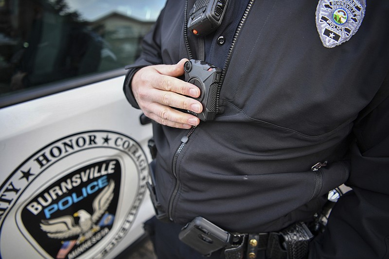 
              In this Feb. 16, 2017 photo, Burnsville Police Sgt. Chris Wicklund turns his his body camera off after completing a call in Burnsville, Minn.  When a Minneapolis police officer shot and killed Justine Damond, who had called in a possible crime in the alley behind her house on July 15, his body camera wasn't running. Criminal-justice experts say the early numbers suggest that officers aren't turning them on often enough, and Minneapolis isn't the only city where that's the case. (Glen Stubbe/Star Tribune via AP)
            