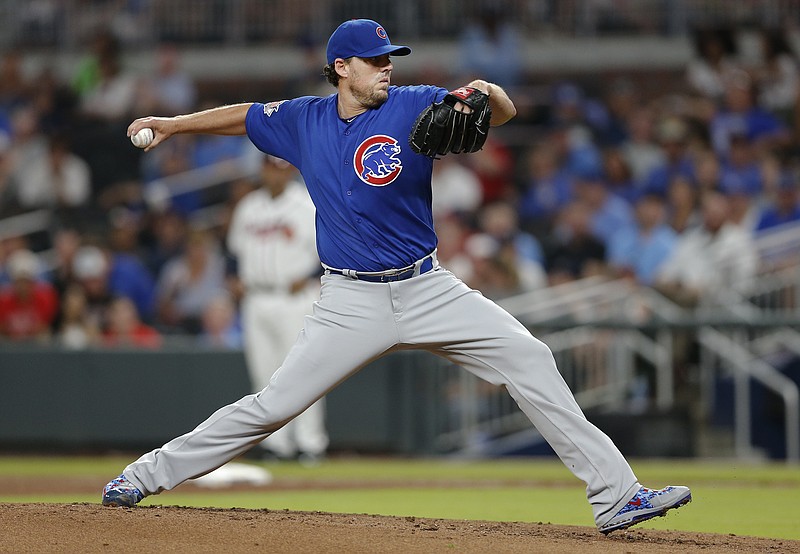 Chicago Cubs starting pitcher John Lackey works in the first inning of the team's baseball game against the Atlanta Braves on Tuesday, July 18, 2017, in Atlanta. (AP Photo/John Bazemore)