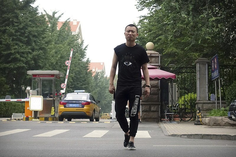 
              A plainclothes security official approaches journalists outside an apartment complex where Liu Xia, widow of late Chinese Nobel Peace Prize laureate Liu Xiaobo, lives in Beijing, Wednesday, July 18, 2017. Supporters of Liu Xiaobo are gathering worldwide to mark the traditional Chinese observance of the seventh day after his death. However, in a leafy apartment complex in west Beijing, more than a dozen men have been holding an around-the-clock vigil with a different purpose altogether: keeping visitors and journalists away from the home Liu shared with his wife, Liu Xia. (AP Photo/Gerry Shih)
            