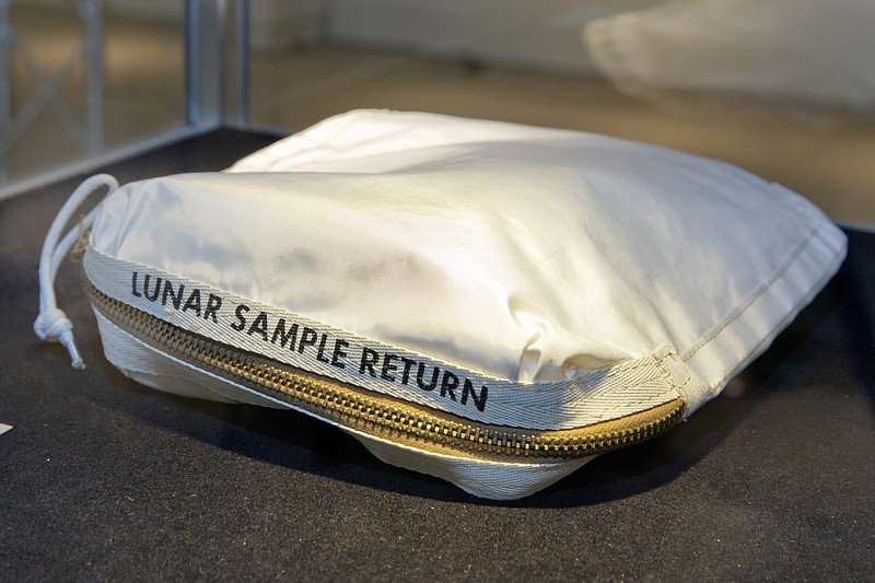 
              The Apollo 11 Contingency Lunar Sample Return Bag used by astronaut Neil Armstrong, to be offered at auction, is displayed at Sotheby's, in New York, Thursday, July 13, 2017. The lunar dust plus some tiny rocks that Armstrong also collected are zipped up in a small bag and are worth an estimated $2 million to $4 million. (AP Photo/Richard Drew)
            