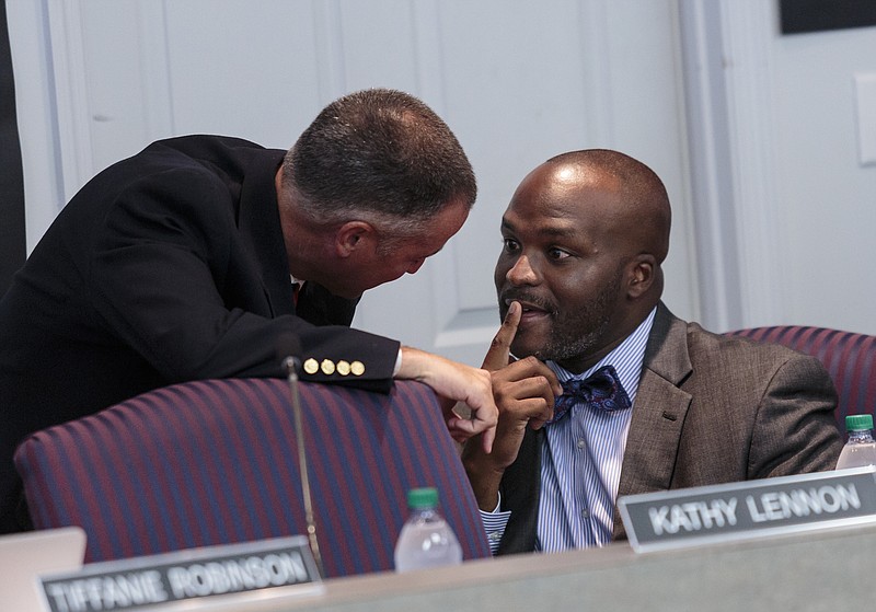 School board member Joe Wingate, left, talks with new schools superintendent Bryan Johnson before a Hamilton County Board of Education meeting on Thursday, July 20, 2017, in Chattanooga, Tenn. The board discussed a school Partnership Zone proposal would create an independent mini-district within Hamilton County as an alternative to complete state takeover of five low-performing schools.