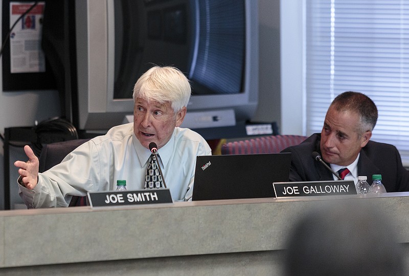 School board members Joe Galloway, left, and Joe Wingate discuss a school Partnership Zone proposal during a Hamilton County Board of Education meeting on Thursday, July 20, 2017, in Chattanooga, Tenn. The school Partnership Zone would create an independent mini-district within Hamilton County as an alternative to complete state takeover of five low-performing schools.