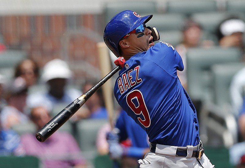 
              Chicago Cubs second baseman Javier Baez (9) watches the flight of the ball as he follows through on three-run home run in the eighth inning of a baseball game against the Atlanta Braves Wednesday, July 19, 2017, in Atlanta. Chicago won 8-2. (AP Photo/John Bazemore)
            