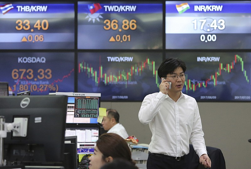 
              A currency trader talks on the mobile phone at the foreign exchange dealing room of the KEB Hana Bank headquarters in Seoul, South Korea, Thursday, July 20, 2017. Asian stock markets rose on Thursday after the Bank of Japan delays timing of achieving its inflation target while record-high closes on Wall Street boosted investor sentiment. (AP Photo/Ahn Young-joon)
            