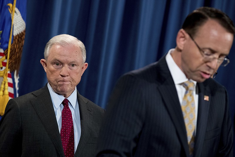 
              Deputy Attorney General Rod Rosenstein, right, accompanied by Attorney General Jeff Sessions, left, speaks at a news conference to announce an international cybercrime enforcement action at the Department of Justice, Thursday, July 20, 2017, in Washington. (AP Photo/Andrew Harnik)
            