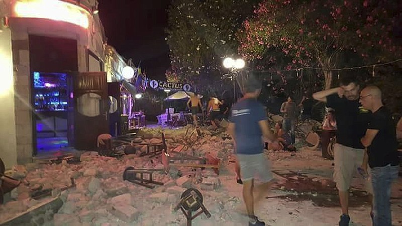 
              A man lies on the ground as other tourists stand outside a bar after an earthquake on the Greek island of Kos early Friday, July 21, 2017. A powerful earthquake struck Greek islands and Turkey's Aegean coast early Friday morning, damaging buildings and a port and killing at least two people, authorities said. (Kostoday.gr via AP)
            