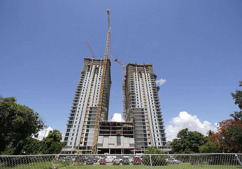 
              This Monday, July 17, 2017, photo shows two condominium high-rises under construction in downtown Miami. On Thursday, July 20, 2017, Freddie Mac reports on the week’s average U.S. mortgage rates. (AP Photo/Alan Diaz)
            