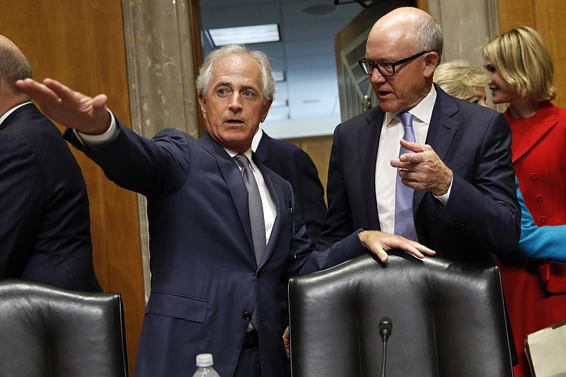 
              Sen. Bob Corker, R-Tenn., left, shows Woody Johnson, owner of the New York Jets, right, where he should sit, as Johnson arrives for a Senate Foreign Relations Committee hearing on his nomination to be Ambassador to the United Kingdom, Thursday, July 20, 2017, on Capitol Hill in Washington. (AP Photo/Jacquelyn Martin)
            