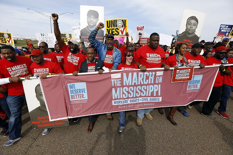 
              In this March 4, 2017 file photograph, thousands march to Nissan Motor Co.'s Canton, Miss., plant, following a pro-union rally.  The United Auto Workers faces a strong anti-union campaign from Nissan Motor Co. as it tries to gain a foothold in the union-averse South by organizing workers at the Japanese automaker’s Mississippi plant. As many as 4,000 workers will vote Aug. 3-Aug. 4, 2017  the vehicle assembly plant in Canton, just north of Jackson. (AP Photo/Rogelio V. Solis)
            