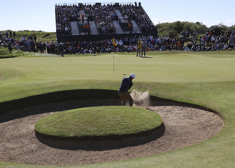 
              Northern Ireland's Rory McIlroy plays out of the bunker on the 7th hole during the first round of the British Open Golf Championship, at Royal Birkdale, Southport, England Thursday, July 20, 2017. (AP Photo/Peter Morrison)
            