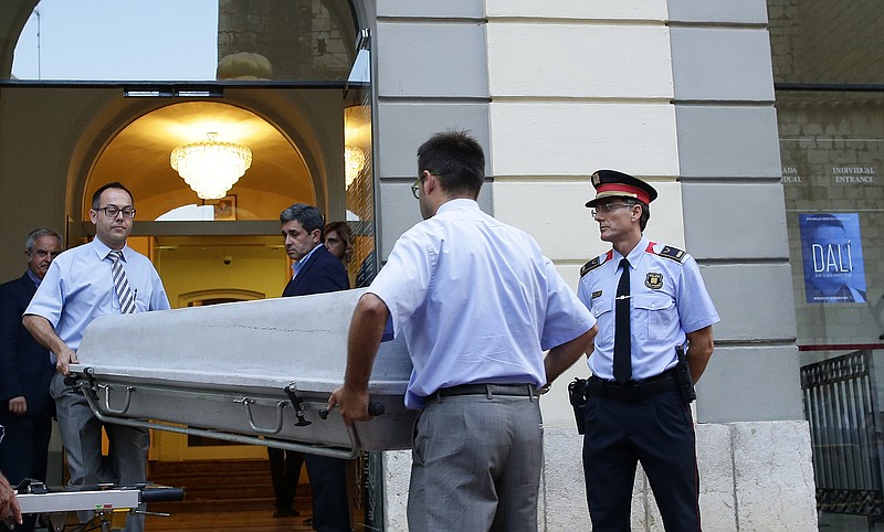
              Workers bring a casket to the Dali Theater Museum in Figueres, Spain, Thursday, July 20, 2017. Salvador Dali's eccentric artistic and personal history took yet another bizarre turn Thursday with the exhumation of his embalmed remains in order to find genetic samples that could settle whether one of the founding figures of surrealism fathered a daughter decades ago. (AP Photo/Manu Fernandez)
            
