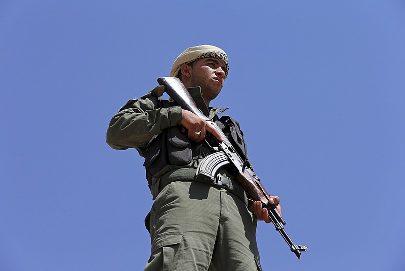 
              A Syrian Internal Security Forces soldier stand guards as his comrades attend their graduation ceremony, at Ain Issa desert base, in Raqqa province, northeast Syria, Thursday, July 20, 2017. Some 250 residents of Syria's Raqqa province are the latest batch to graduate from a brief U.S-training course that is preparing an internal security force to hold and secure areas as they are captured from Islamic State militants.(AP Photo/Hussein Malla)
            