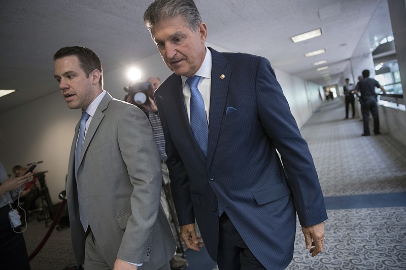 
              Sen. Joe Manchin, D-W.Va., center, a member of the Senate Intelligence Committee, leaves after a closed-door meeting of that panel on Capitol Hill in Washington, Thursday, July 20, 2017. The Senate intelligence committee has scheduled perhaps the most high-profile testimony involving the Russian meddling probes since former FBI Director James Comey appeared in June. A lawyer for Trump's powerful son-in-law and adviser says Jared Kushner will speak to the Senate intelligence committee Monday. Donald Trump Jr. is scheduled to appear before the Senate Judiciary Committee next Wednesday along with former campaign chairman Paul Manafort. (AP Photo/J. Scott Applewhite)
            