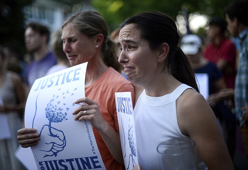 
              Betsy Custis, right, and others attend a march in honor of Justine Damond at Beard's Plaissance Park, Thursday, July 20, 2017, in Minneapolis. Damond, of Australia, was shot and killed by a Minneapolis police officer on Saturday, July 15 after calling 911 to report what she believed was a possible assault. (Aaron Lavinsky/Star Tribune via AP)
            