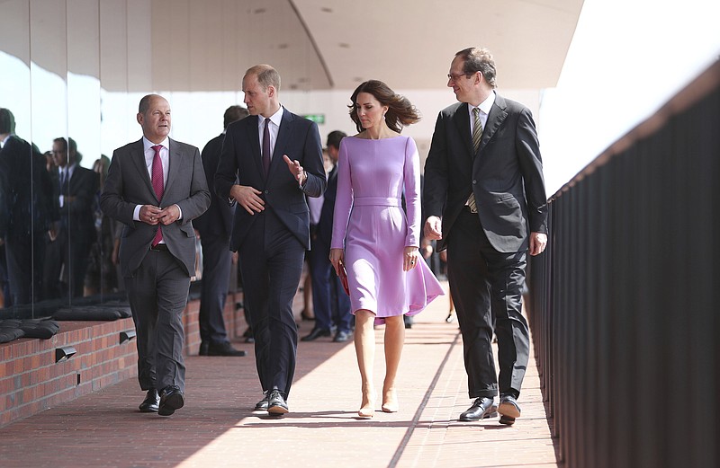
              From left : Hamburg's mayor Olaf Scholz, Britain's Prince William, his wife, Kate, the Duchess of Cambridge and the artistic director of the Elbphilharmonie, Christoph Lieben-Seutter,  walk on the terrace of the Concert Hall in Hamburg, Germany, Friday, July 21, 2017.  (Christian Charisius/Pool Photo via AP)
            