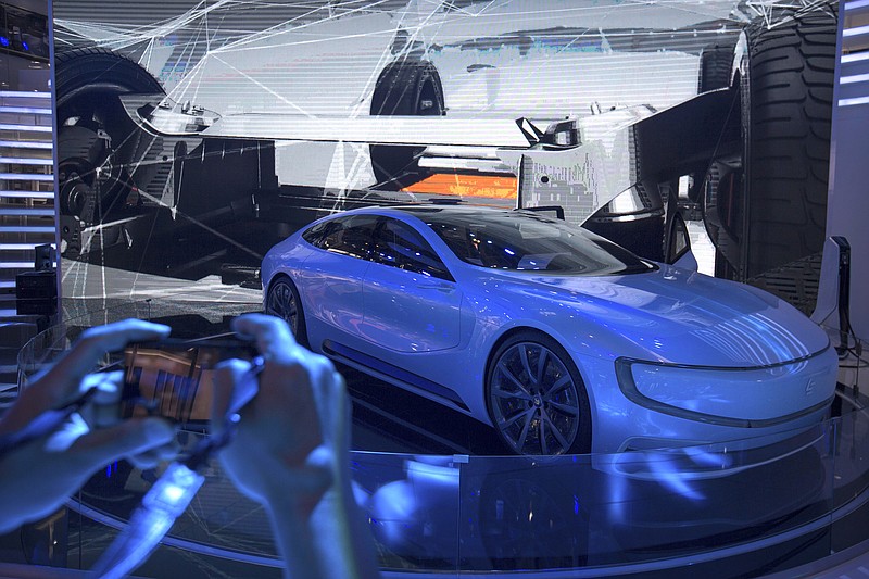 
              In this April 26, 2016 photo, a visitor takes a photo of a LeEco LeSEE self-driving electric concept car at the Beijing International Automotive Exhibition in Beijing. China's government announced Thursday, July 21, 2017, a goal of transforming the country into a global leader in artificial intelligence in just over a decade, putting additional political support behind growing investment by Chinese companies in developing self-driving cars and other advances. (AP Photo/Mark Schiefelbein)
            