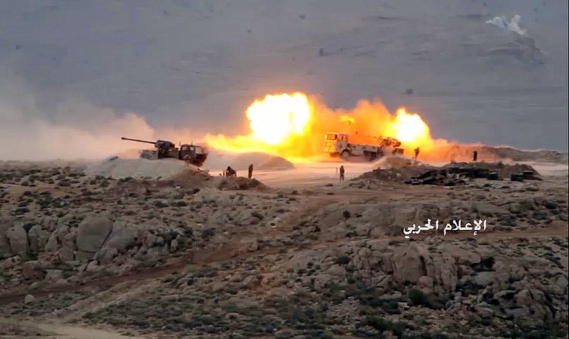 
              This Friday, July 21, 2017 photo, released by the government-controlled Syrian Central Military Media, shows Hezbollah cannons pounding militants' positions on the Lebanon-Syria border. The Syrian army and members of Lebanon's militant Hezbollah group launched a major ground offensive on Friday aiming to end years long presence of hundreds of militants in a border area between the two countries. (Syrian Central Military Media, via AP)
            