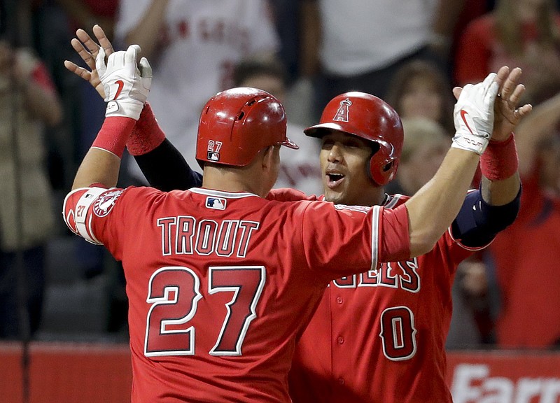 
              Los Angeles Angels' Mike Trout, left, celebrates his two-run home run with Yunel Escobar during the seventh inning of the team's baseball game against the Washington Nationals in Anaheim, Calif., Wednesday, July 19, 2017. (AP Photo/Chris Carlson)
            