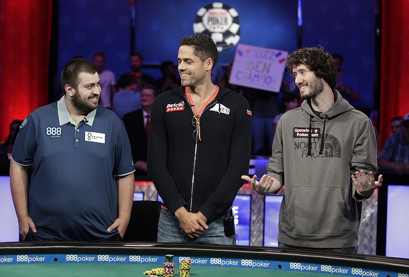 
              The final three players, from left, Scott Blumstein; Benjamin Pollak, of France; and Dan Ott stand at the final table during the World Series of Poker, Friday, July 21, 2017, in Las Vegas. (AP Photo/John Locher)
            