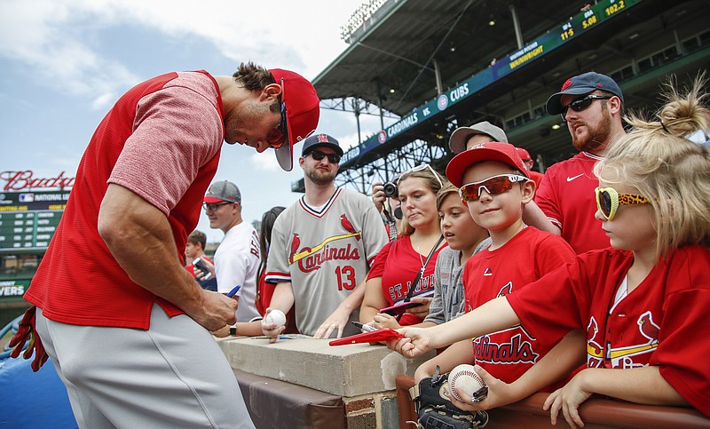 
              St. Louis Cardinals' Randal Grichuk signs autographs before a baseball game against the Chicago Cubs, Saturday, July 22, 2017, in Chicago. (AP Photo/Kamil Krzaczynski)
            