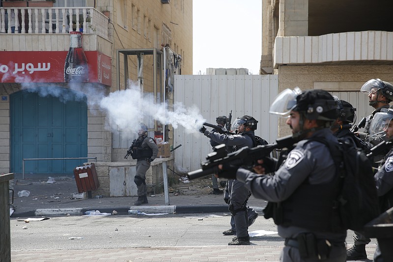 
              Israeli border border police fire tear gas at Palestinians during clashes in the West Bank city of Bethlehem, Friday, July 21, 2017. Israel police severely restricted Muslim access to a contested shrine in Jerusalem's Old City on Friday to prevent protests over the installation of metal detectors at the holy site.(AP Photo/Nasser Shiyoukhi)
            