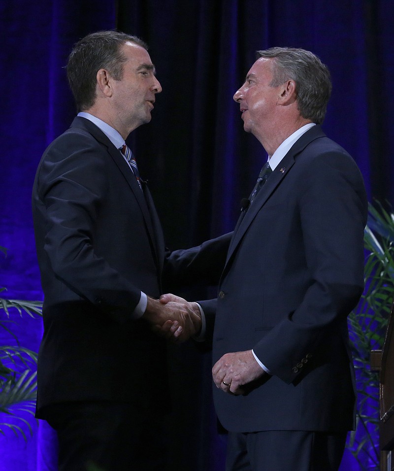 
              Democratic gubernatorial candidate Lt. Gov. Ralph Northam, left, and GOP gubernatorial candidate Ed Gillespie, shake hands on stage at the Omni Homestead Resort in Hot Springs, Va., Saturday, July 22, 2017.  The two major party candidates in Virginia's closely watched race for governor clashed at their first debate over President Donald Trump, health care, immigration, and social issues. ( Bob Brown/Richmond Times-Dispatch via AP)
            