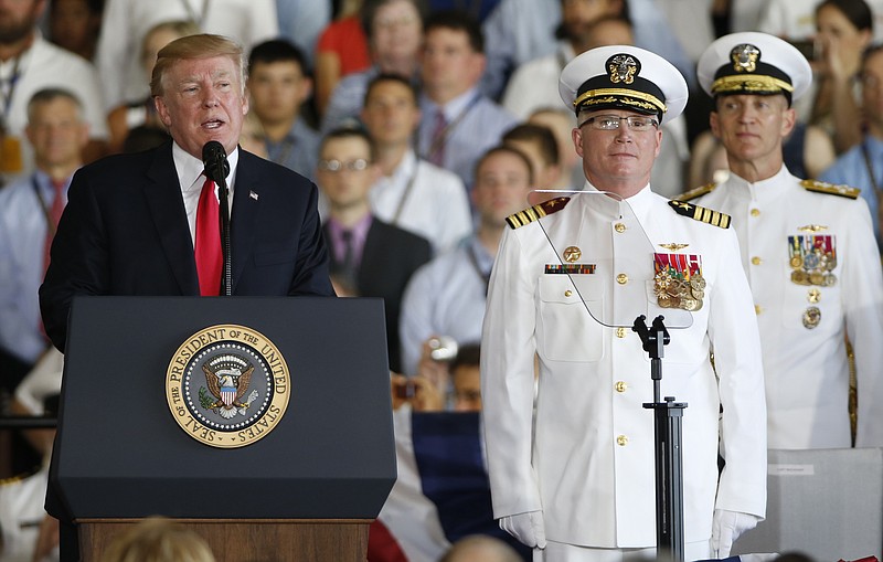 President Donald Trump, left, puts the USS Gerald Ford into commission as Ships commander Capt. Richard McCormack, front right, listens aboard the nuclear aircraft carrier USS Gerald R. Ford for it's commissioning at Naval Station Norfolk in Norfolk, Va., Saturday, July 22, 2017. (AP Photo/Steve Helber)