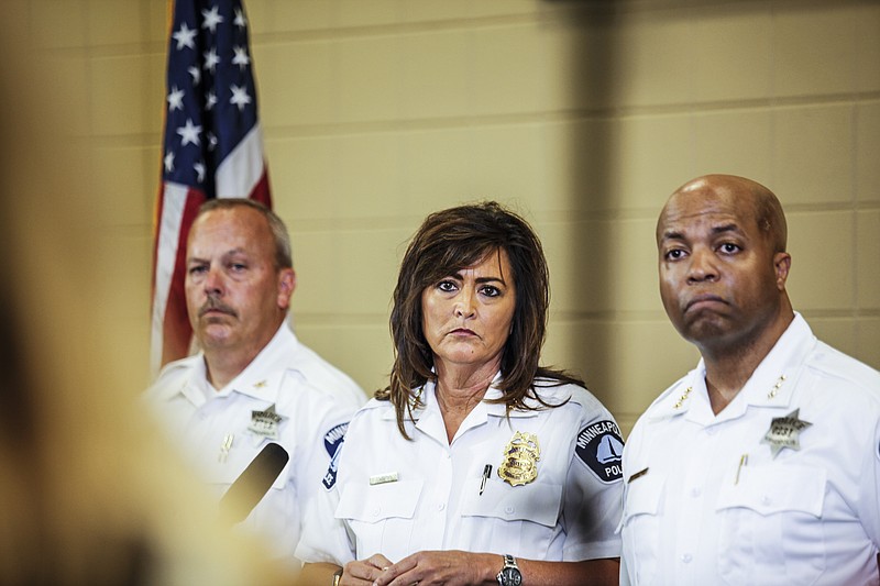 
              Minneapolis police chief Janee Harteau, center, stands with police inspector Michael Kjos, left, and assistant chief Medaria Arradondo during a news conference Thursday, July 20, 2017, Minneapolis. It was the first time she appeared publicly since the police shooting death of Justine Damond on Saturday. (Maria Alejandra Cardona/Minnesota Public Radio via AP)
            